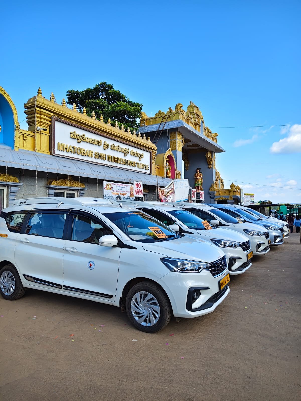 Coastal Tours And Travels taxi fleet parked outside Murdeshwar Temple